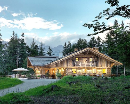 Exterior view of the illuminated Interalpen-Alm in summer