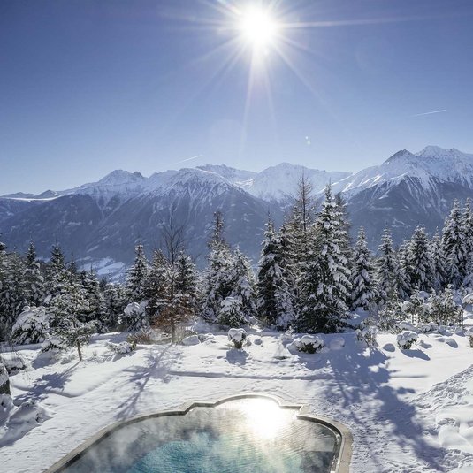 View of the large outdoor pool in the garden of the 5 star superior Interalpen-Hotel Tyrol